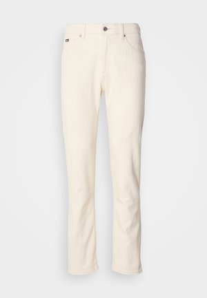 Off-white straight-leg jeans met knoopsluiting, riemlussen en voorzakken tegen een effen achtergrond.