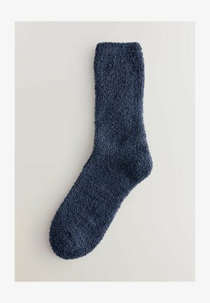 Granatowe, miękkie, puszyste skarpetki wykonane z pluszowego materiału; mają zaokrąglony palec i ściągacz na górze. Odpowiednie do noszenia na co dzień.
