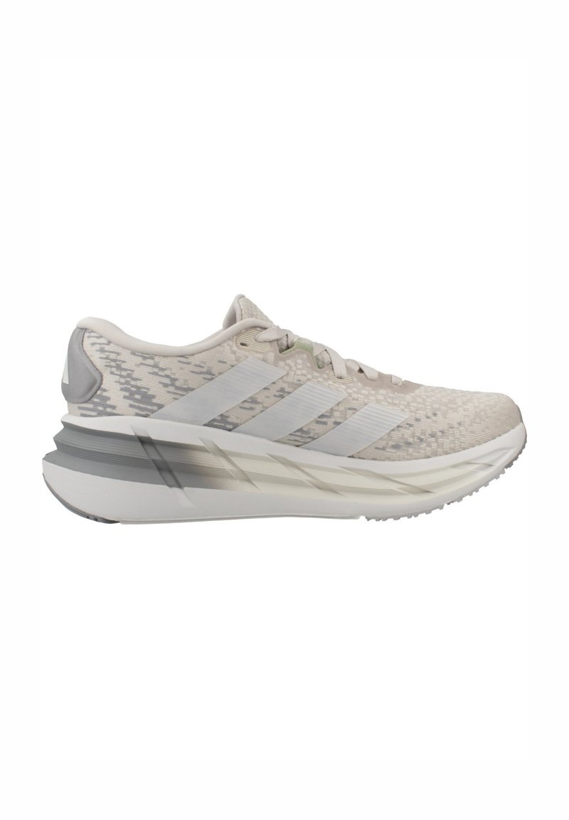 Light beige and gray running shoe with patterned fabric upper, three translucent side stripes, thick cushioned sole, and laces.