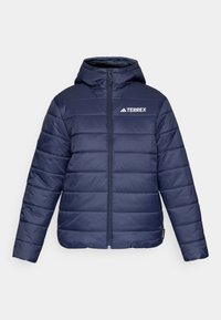 Marineblaue Steppjacke mit Kapuze, horizontaler Steppung, Frontreißverschluss und weißem TERREX-Logo auf der linken Brust. Strukturiertes, leichtes Material.