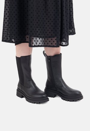 Schwarze Leder Stiefeletten mit dicker Sohle und Reißverschluss, mit glatter Textur und rundem Zehenbereich.