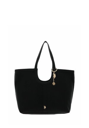 Sac cabas noir avec doubles poignées, breloque dorée et petit emblème décoratif sur le devant, sur fond blanc.