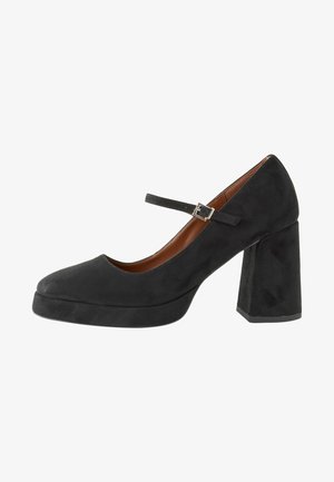 Scarpa nera in suede con tacco alto, punta arrotondata, cinturino alla caviglia e tacco quadrato spesso. Texture liscia con minimi dettagli.