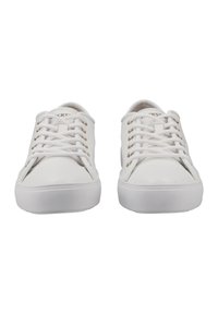 White lace-up sneakers made of smooth synthetic material, featuring gold-tone eyelets and a flat rubber sole.