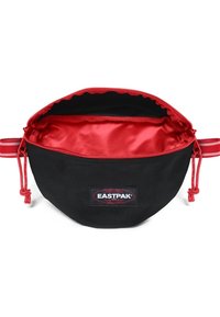 Black fabric pouch with a red inner lining, drawstring closure, Eastpak logo, and side straps for carrying or attachment.