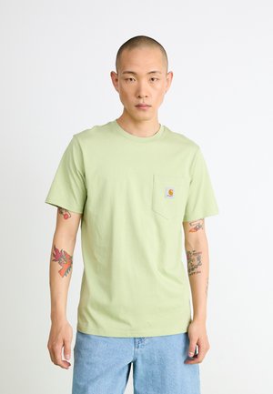 Light green cotton t-shirt featuring short sleeves, a round neck, and a chest pocket with a logo. Worn with light blue denim pants.