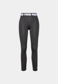 Mustat urheiluhousut joustavasta kankaasta, joissa on leveä valkoinen vyötärönauha, jossa lukee "PUMA" ja pieni logo nilkassa.