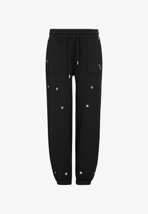 Czarne spodnie dresowe z elastycznym pasem, dwoma dużymi przednimi kieszeniami, zatrzaskami i ściągaczami u dołu nogawek.