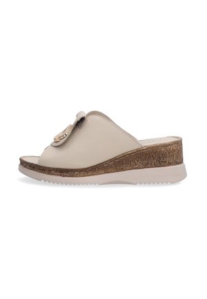 Beige leather slide sandal with a rounded toe, textured cork wedge sole, and a decorative gold accent on the strap. Features a low heel.