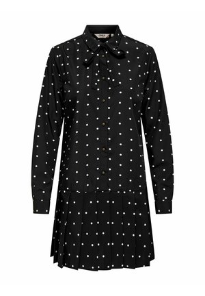 Sort skjortekjole med hvite polkadotter, lange ermer, sløyfe i kragen, knapper foran og plissért skjørtedetalj. Stoff av bomullsblanding.