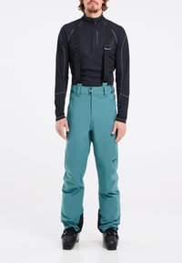 Pantalones de esquí turquesa con tirantes ajustables, diseño recto y puños negros reforzados. Fabricados con material duradero y resistente a la intemperie.