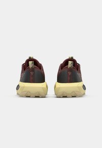 Trail running shoes with a maroon upper, black accents, a textured sole, and a yellow midsole. Features a pull tab and patterned detailing.