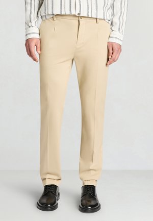 LUNGO TINTA UNITA - Stoffhose - beige