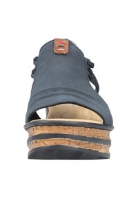 Black open-toe sandal with a textured cork platform, leather accent near the laces, and a smooth fabric upper.