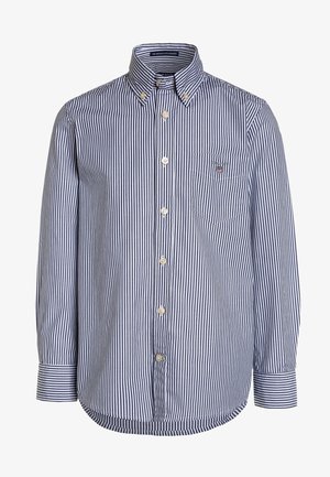 Langærmet skjorte med knapper og lodrette marineblå og hvide striber, krave med knapper, brystlomme med logo og manchetter med knapper.