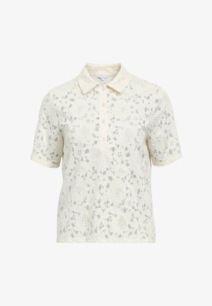 Blouse crème à manches courtes en dentelle avec motif floral, col chemise et patte de boutonnage à trois boutons.