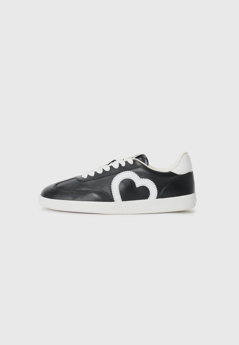 Black low-top sneaker with white laces, white sole, and a white heart-shaped design on the side.