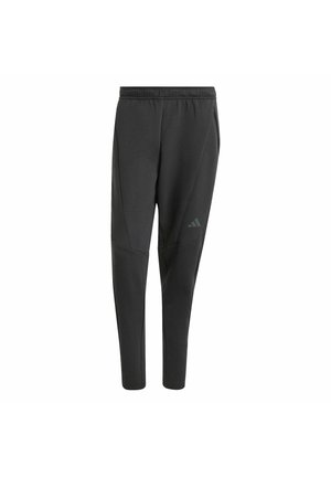 Pantalon de sport noir ajusté avec taille élastique et poches latérales, avec un petit logo Adidas sur la cuisse droite.