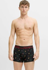 Zwarte katoenen boxershorts met feestelijke patronen, voorzien van een rode tailleband met het label "JACK & JONES," en illustraties van kerstversieringen.