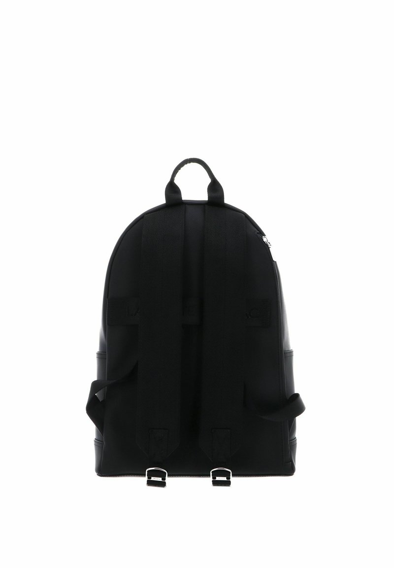 Black backpack with a rounded shape, dual adjustable straps, top handle, and silver hardware accents at the base for securing additional items.