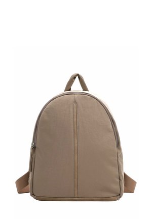 Beige fabric backpack with a rounded shape, featuring a top handle, side zip, and a smooth, matte texture. Accents in a darker shade.
