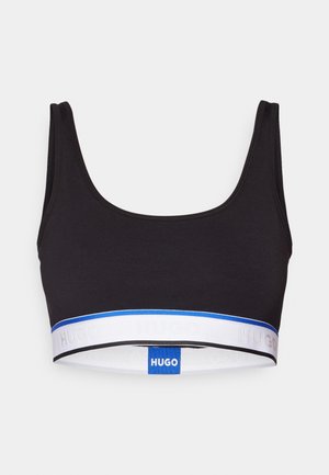 Crop top noir en tissu lisse, avec une large bande élastique blanche et bleue portant le logo "HUGO". Encolure arrondie et sans manches.