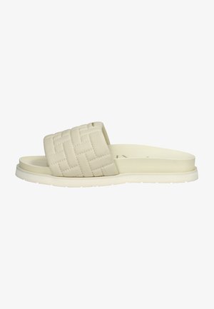 Cream-colored slide sandal with a wide, padded, woven strap and a flat, textured sole.