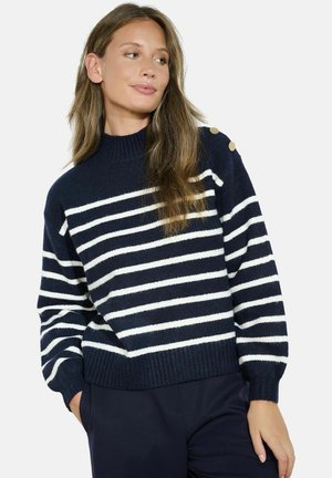 Maglione a righe blu navy e bianco con collo alto, polsini e orlo a costine. Presenta dettagli in oro con bottoni sulle spalle. Tessuto morbido.