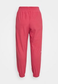 Calças de jogging em mistura de algodão em rosa brilhante, com cintura elástica, tornozelos ajustados e um pequeno detalhe de logótipo na parte inferior da perna.