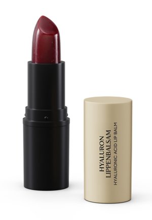 Dark red lipstick in black tube with beige cap labeled "Hyaluron Lippenbalsam Hyaluronic Acid Lip Balm" on white background.