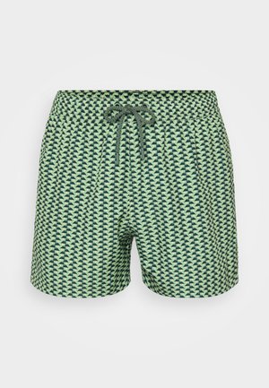 Green patterned swim shorts featuring a geometric design, elastic waistband with drawstring, and smooth fabric texture.