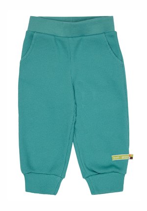 Tealfarbene, strukturiert gewebte Hose mit breitem Gummibund und zwei Seitentaschen. Mit gerippten Bündchen und einem kleinen Markenetikett an der Seite.