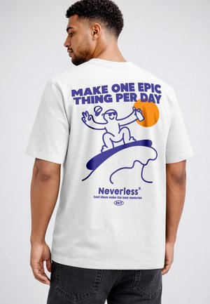 Man wearing white T-shirt with graphic of a smiling figure surfing, holding a drink, with text "Make one epic thing per day" and "Neverless."