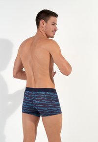 Navy boxer shorts with a blue abstract pattern, featuring a solid black waistband. Fabric appears smooth and stretchy, fitting snugly.