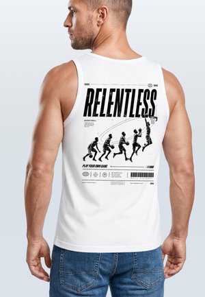 Man in white sleeveless shirt with black basketball-themed graphic and the word "Relentless" on the back, wearing blue jeans, facing left.