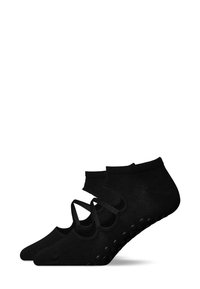 Calzini alla caviglia neri con superficie testurizzata, caratterizzati da cinturini incrociati e grip in gomma punteggiata sulla suola per una maggiore trazione.