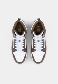 Brown and white high-top sneakers with a perforated toe, solid brown accents, white laces, and a logo on the heel.