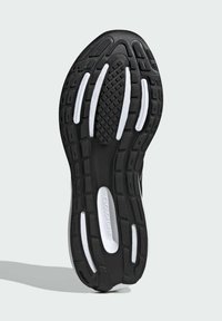 Suela de zapato atlético negro con goma texturizada, detalles en blanco y ranuras para tracción. Marca "CLOUDFOAM" notablemente visible.