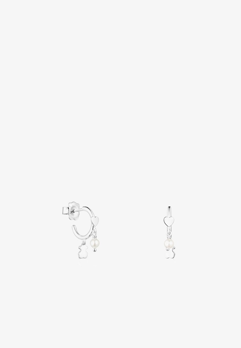 Des boucles d'oreilles en forme de créoles en argent présentent un charme en forme de cœur et un charm en ours suspendu avec un accent en perle, mettant en valeur une finition polie et un design intriqué.