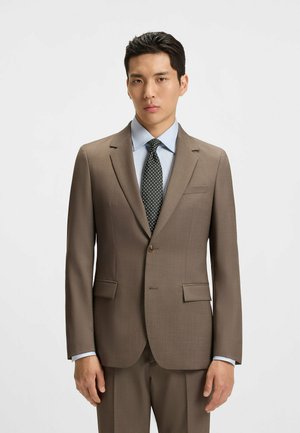 Brown tailored suit jacket with notched lapels, two front pockets, and single-button closure over a light blue striped shirt and patterned tie.
