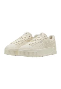 Zapatillas beige con un upper de tela texturizada, diseño de cordones y una suela gruesa y estriada. Presentan un sutil detalle del logotipo en los lados.