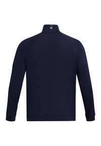 Chaqueta térmica azul marino con cuello alto, mangas largas y puños elásticos; presenta una textura suave y un logotipo sutil en el cuello.