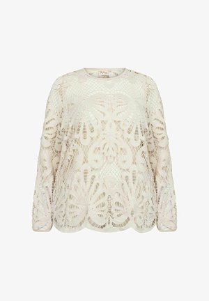 Kreemikas lace-blus, millel on keerukad lillemustrid, pikad varrukad ja ümar kaelus, millel on veidi vabam lõige.