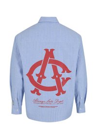 Button-up shirt in light blue with white vertical stripes. Features a large red logo and text on the back. Cotton material, long sleeves.