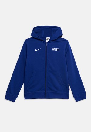 Sweat à capuche Nike bleu zippé intégralement, avec capuche, poches avant, logo Nike blanc sur la poitrine gauche et texte "ATLETI" sur la poitrine droite.