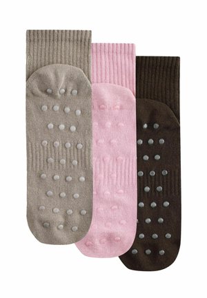 Three pairs of ribbed non-slip socks in beige, pink, and dark brown, each with raised grip dots on the soles.