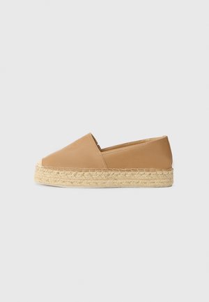 Tan espadrille with a smooth leather upper, round toe, and braided jute sole. Simple design, low profile, and no visible hardware.