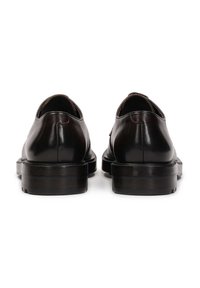 Zapatos de cuero negros con un acabado liso, punta redondeada y un tacón bajo en bloque. Presentan costuras mínimas y una silueta elegante y limpia.