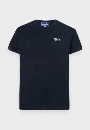 Tamsiai mėlynas trumpomis rankovėmis marškinėlis, pagamintas iš medvilnės, su mažu baltu logotipu ant krūtinės. Įprasto kirpimo su apvaliu iškirpimu.