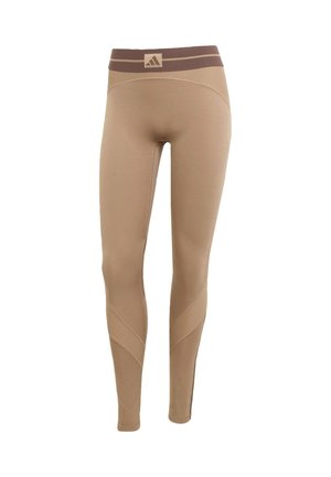 Beige leggings met een textured, donkerbruine tailleband, voorzien van gebogen naaddetails en een aansluitende pasvorm voor sportkleding.